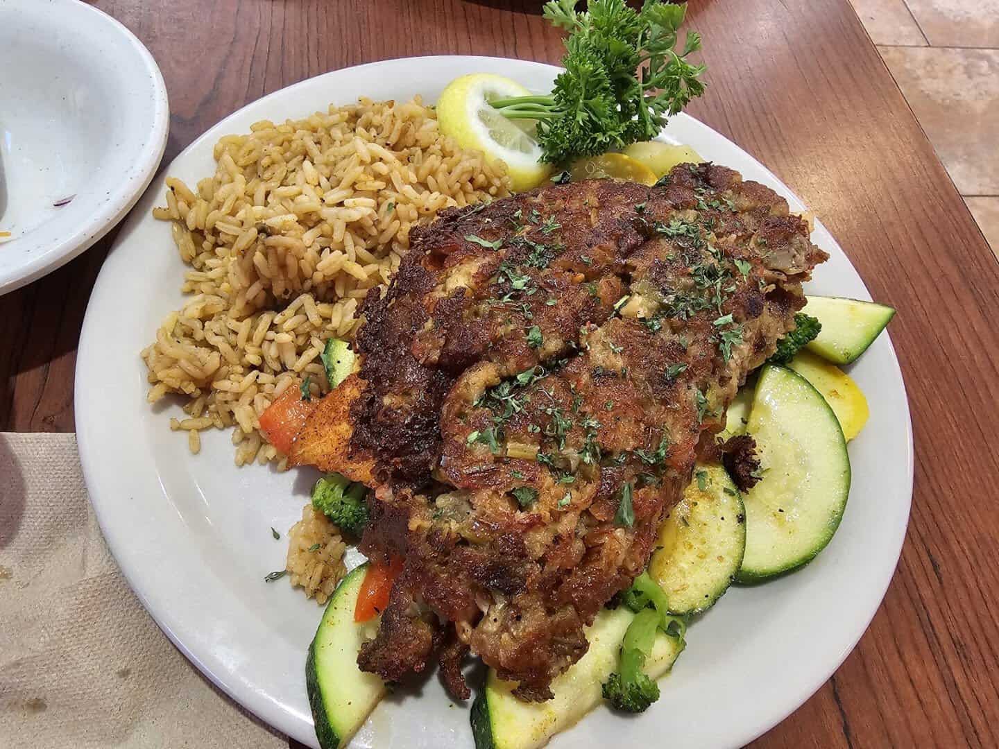 Blackened fish over rice with vegetables at Baytown Seafood in Baytown, Texas