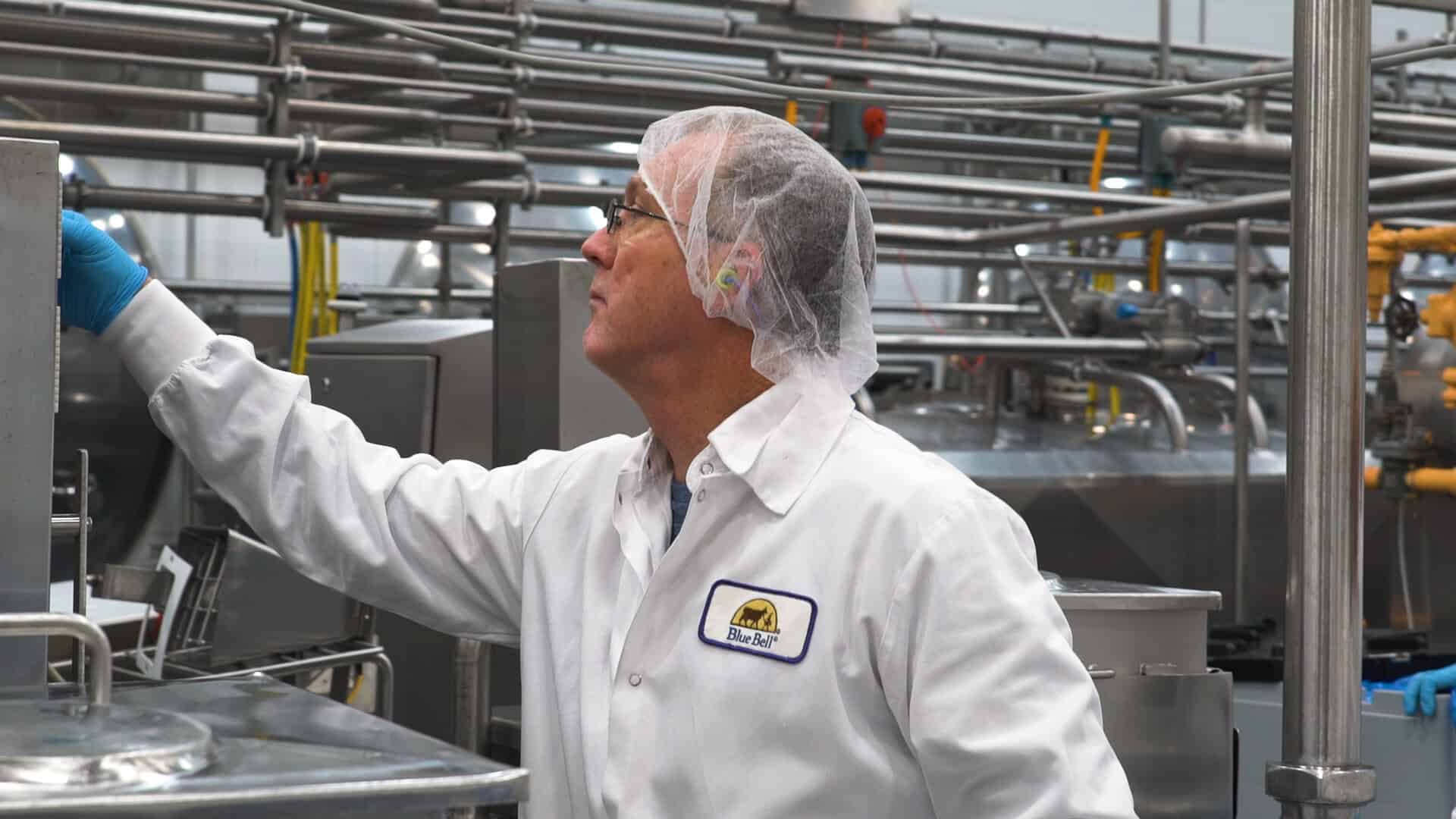 A Blue Bell worker inspecting ice cream on the production line in Brenham, Texas