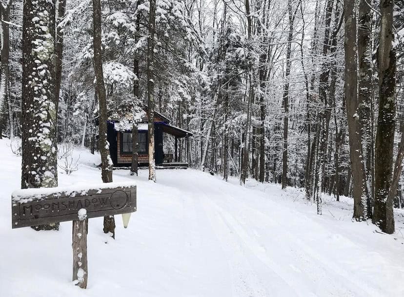 Small wood cabin tucked in a snowy forest, Blue Moon Rising, McHenry, Maryland