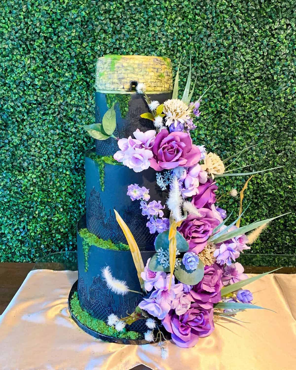 Tall blue gluten-free cake with sugar flowers at Sweet Gilly's