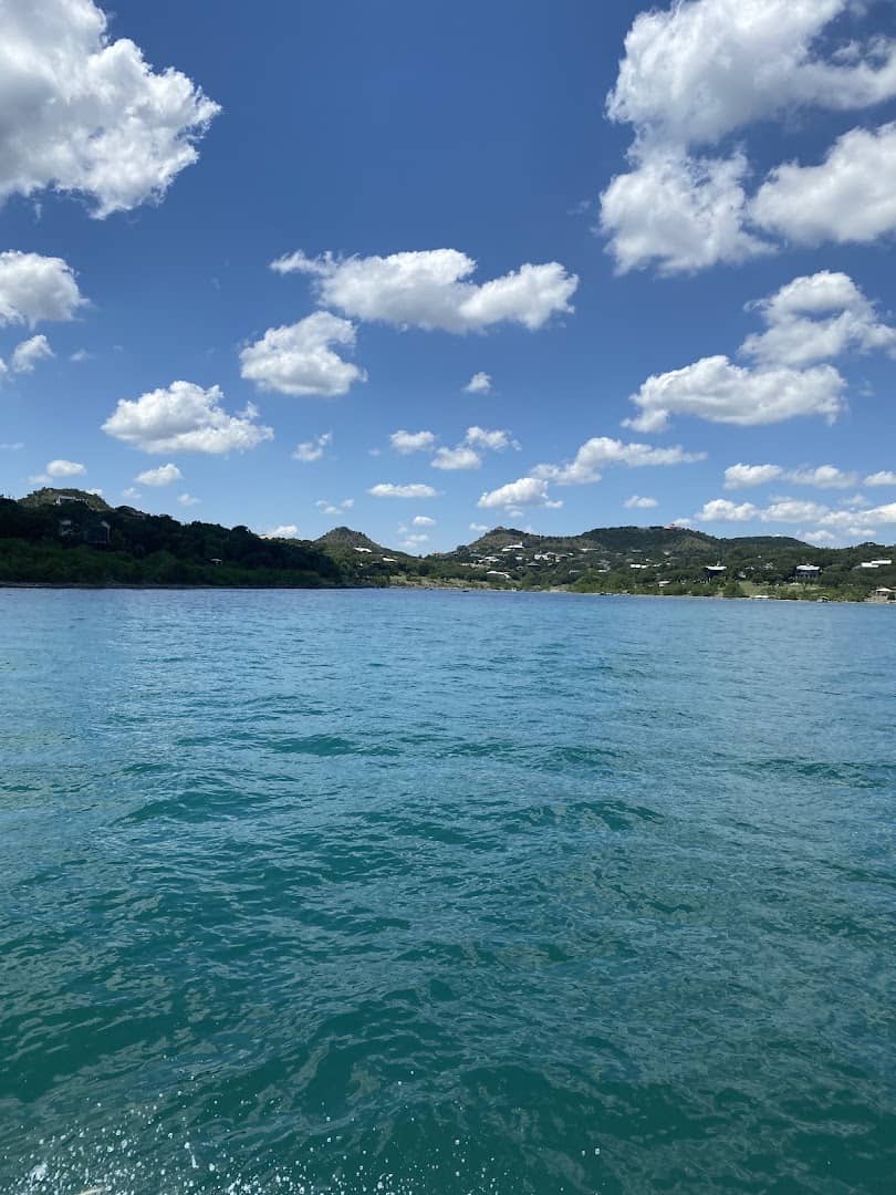 Deep blue water and puffy clouds over Canyon Lake, Texas