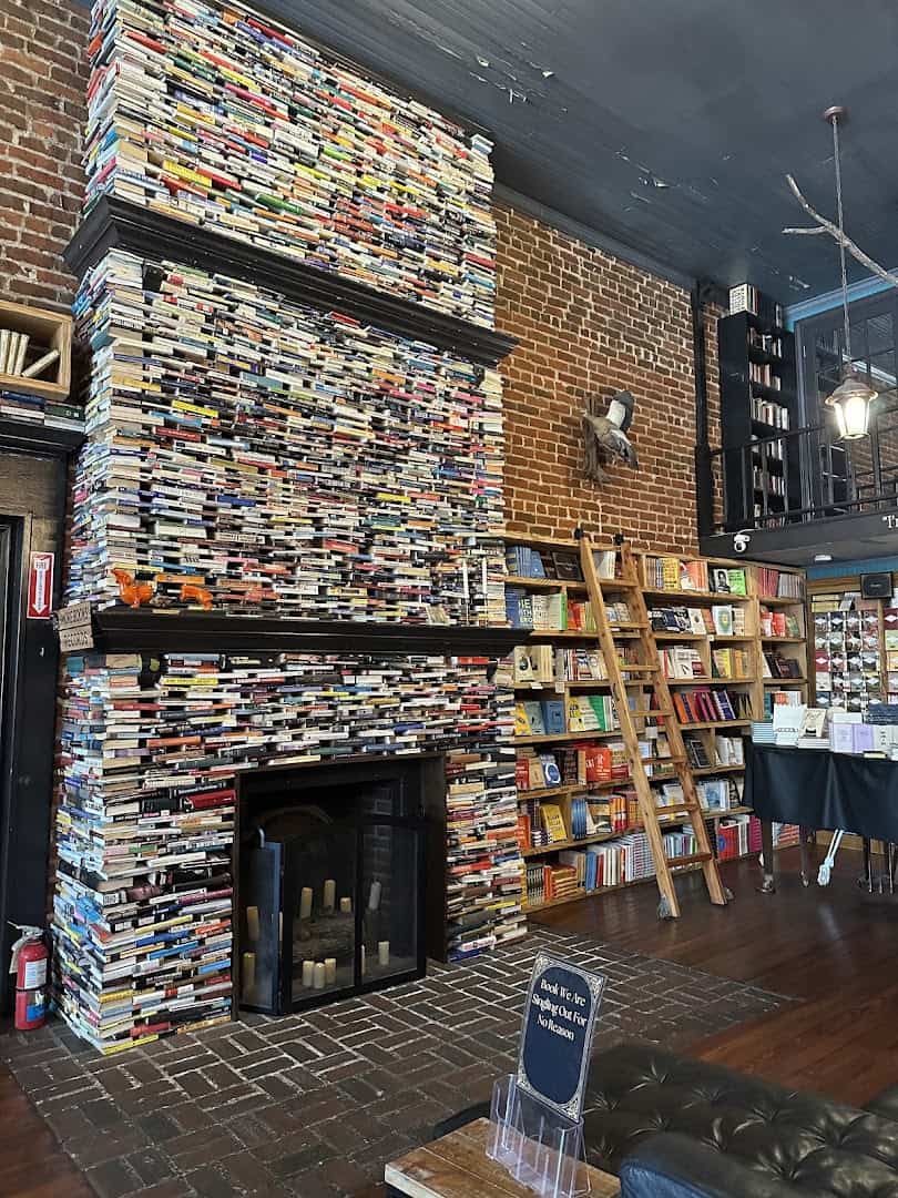 Two-story fireplace built entirely of stacked books at The Painted Porch Bookshop in Bastrop, Texas
