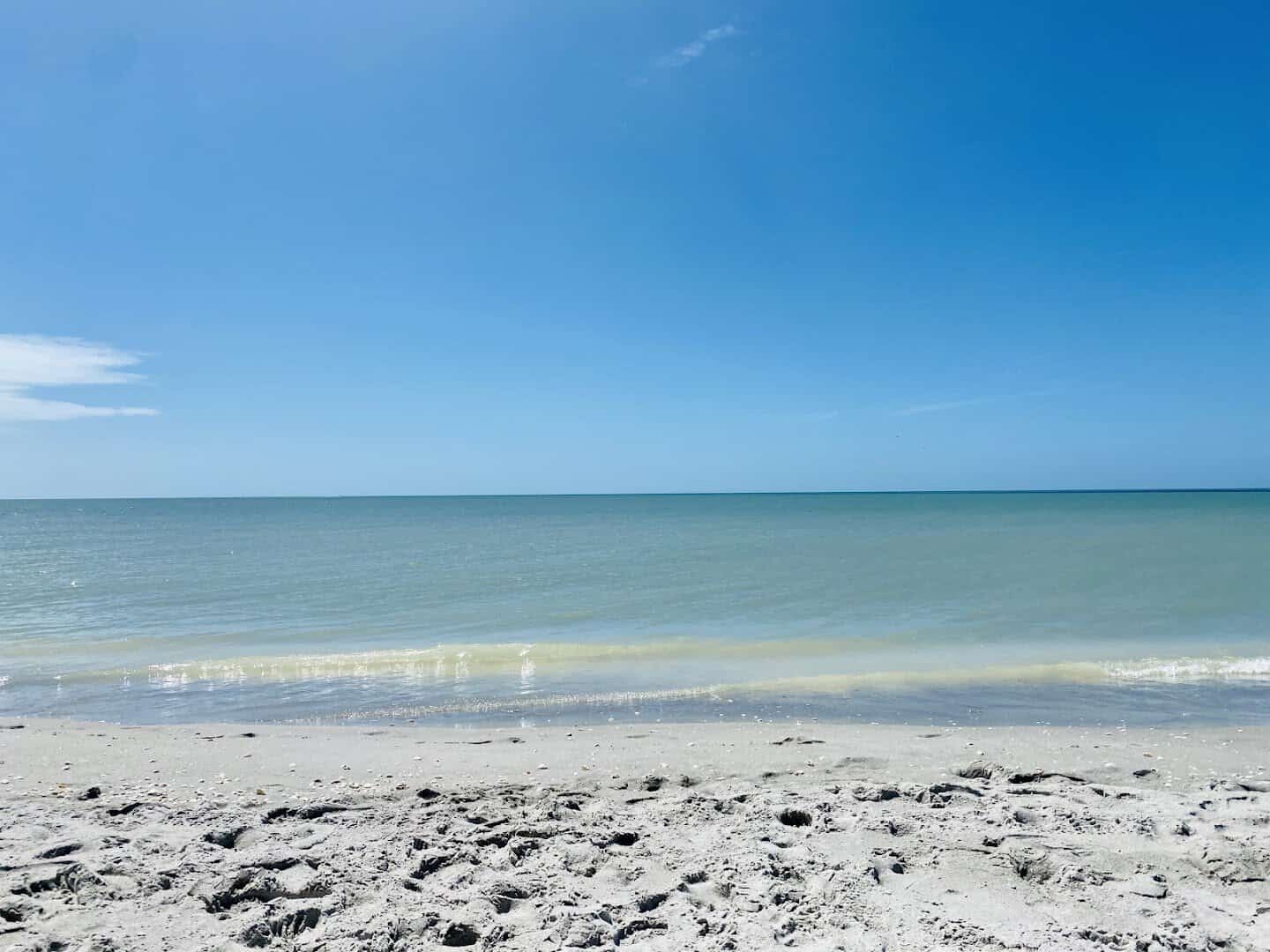 Wide white-sand shoreline and turquoise Gulf water at Bowman's Beach on Sanibel Island, Florida