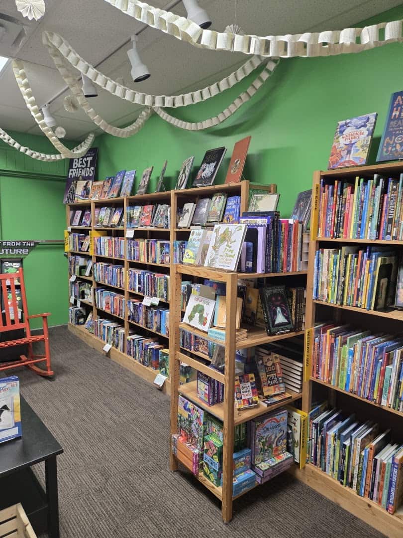 Green-walled interior with book shelves at Brazos Bookstore in Houston
