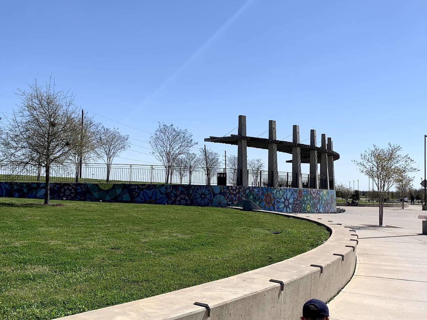 Paved bike trail curving through Brazos River Park in Sugar Land, Texas