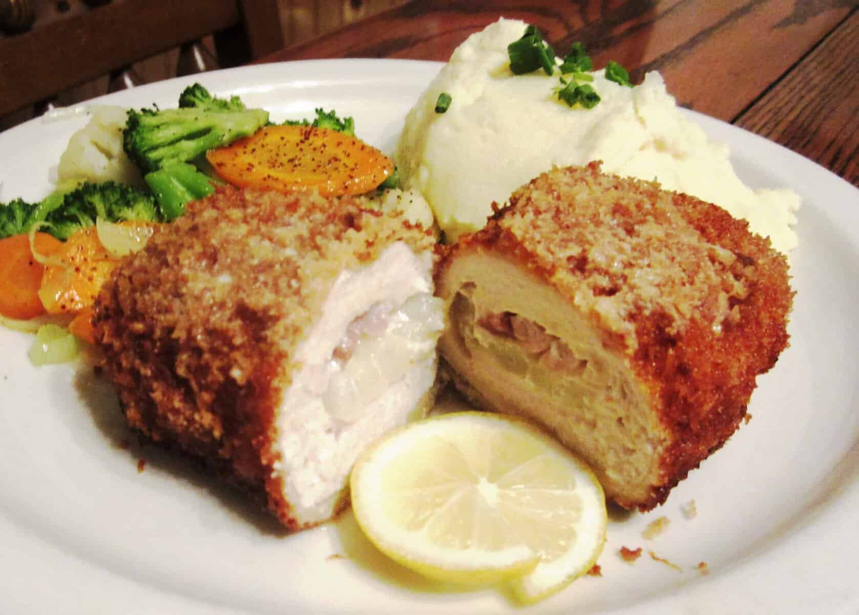 Breaded schnitzel cut open with lemon and mashed potatoes at Bavarian Grill in Plano