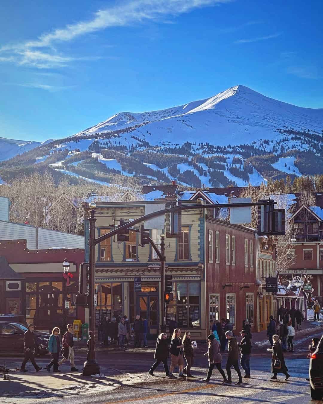 Snow-covered Peak 8 ski mountain rising over the Victorian storefronts of Main Street in Breckenridge, Colorado, in winter
