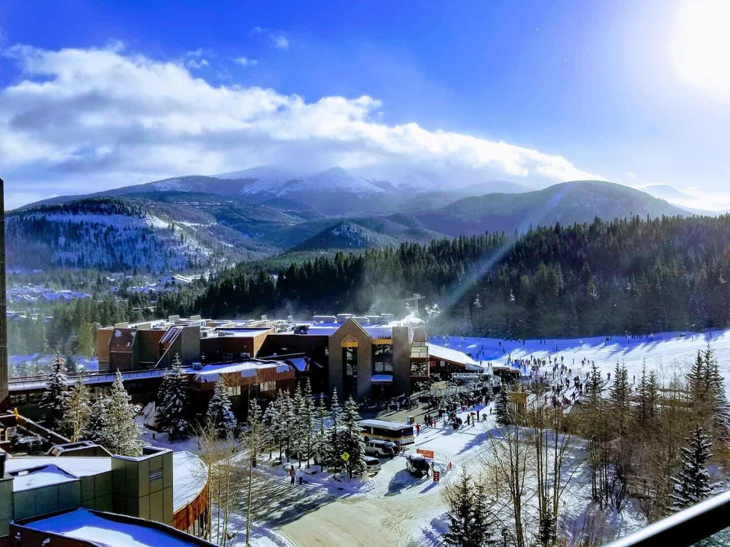Snow-covered Breckenridge ski resort base village with skiers and snowy peaks, Breckenridge, Colorado