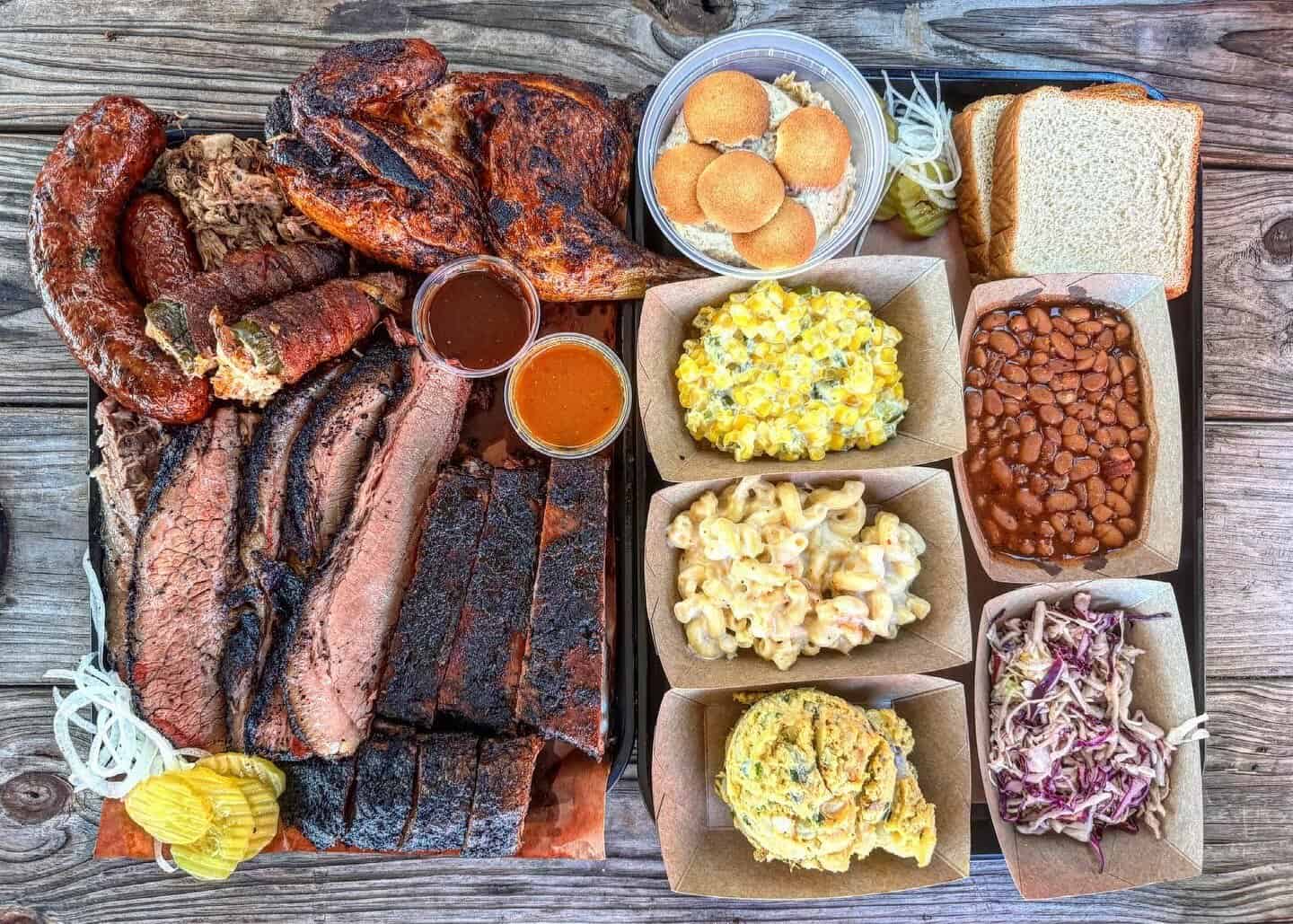 Platter of sliced brisket sausage links and sides at Brendyns BBQ in Nacogdoches