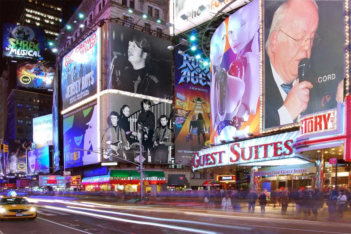 Illuminated marquees along Broadway in the Theater District at night, New York City