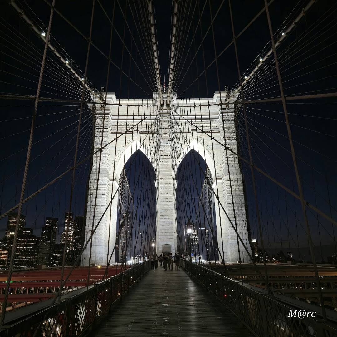 The Brooklyn Bridge pedestrian promenade and Gothic stone tower, New York City