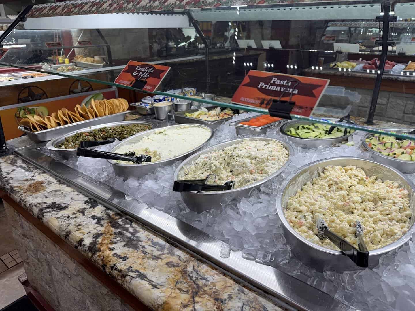 Salad bar and cold line with rice salads and tostadas at Ranchero King Buffet in Houston