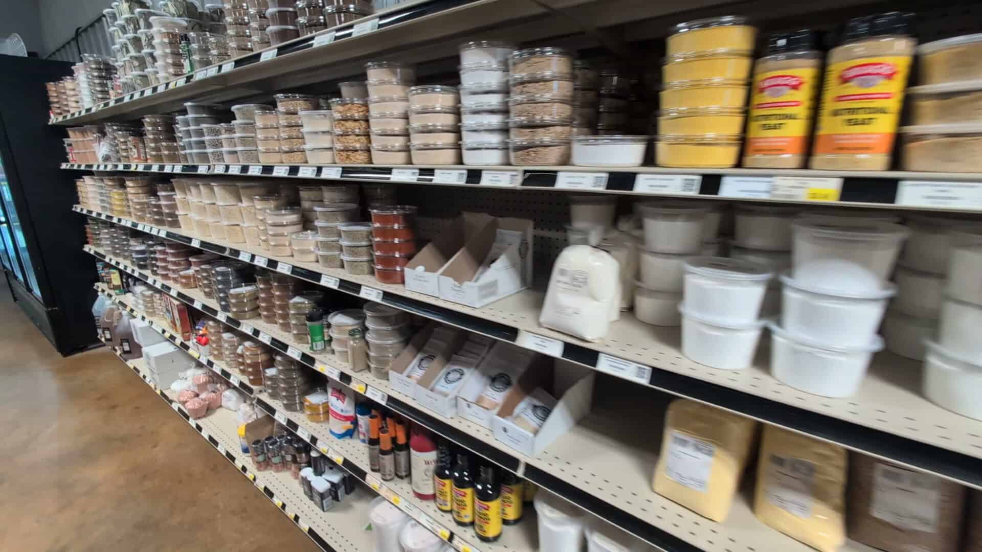 Shelves of bulk spices and baking supplies in tubs at Olde Towne Country Store in Itasca Texas