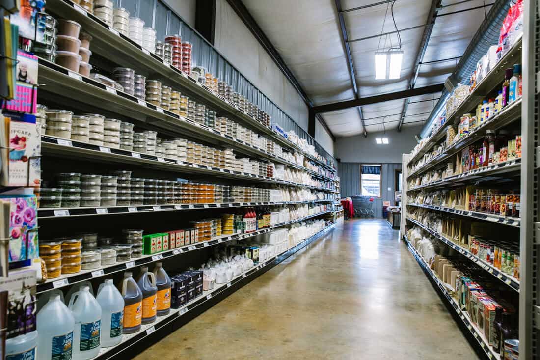 Aisle of bulk food bins and jugs at Olde Towne Country Store in Itasca Texas