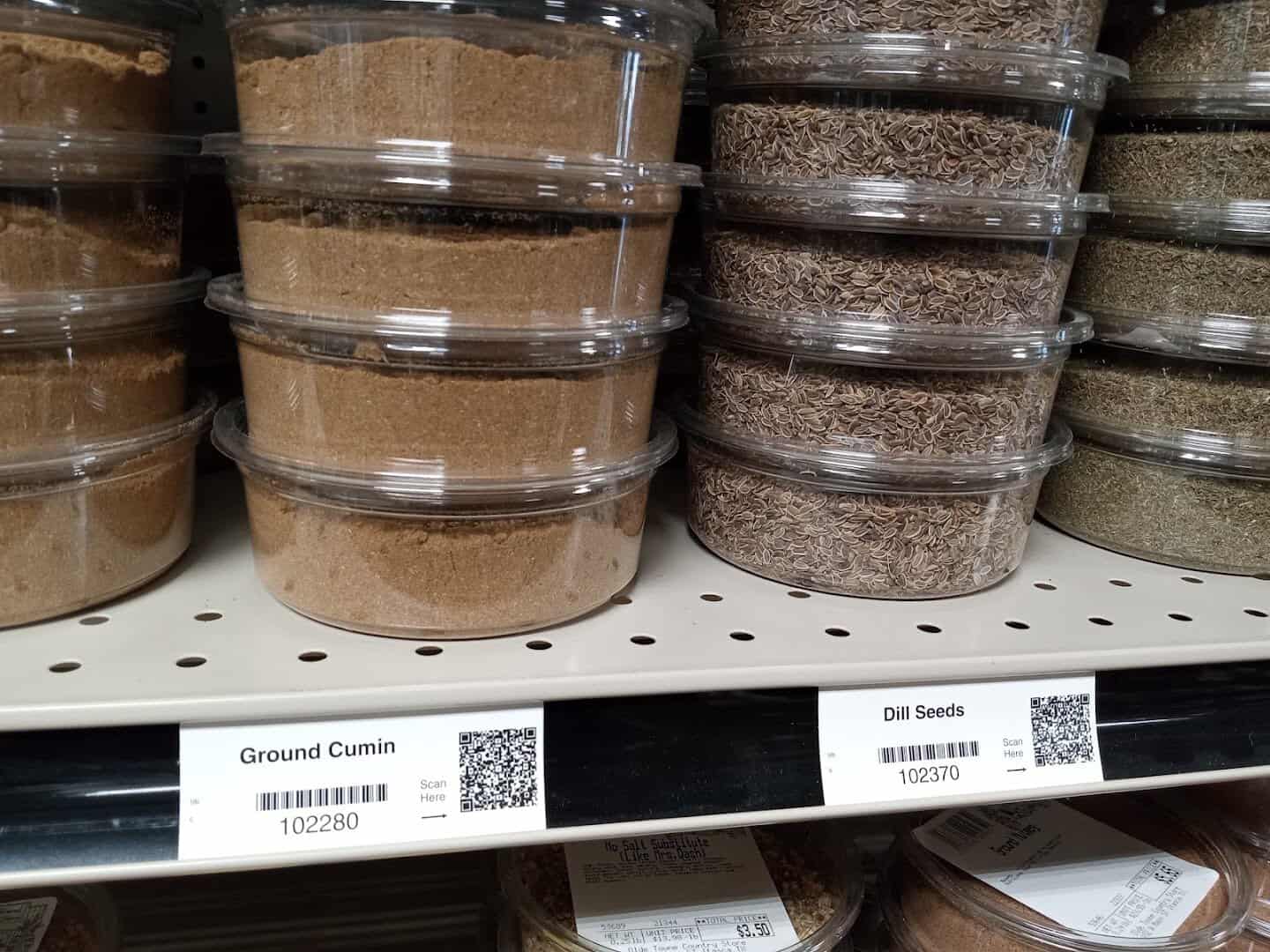 Bulk spice bins of ground cumin and dill seed at Olde Towne Country Store in Itasca, Texas