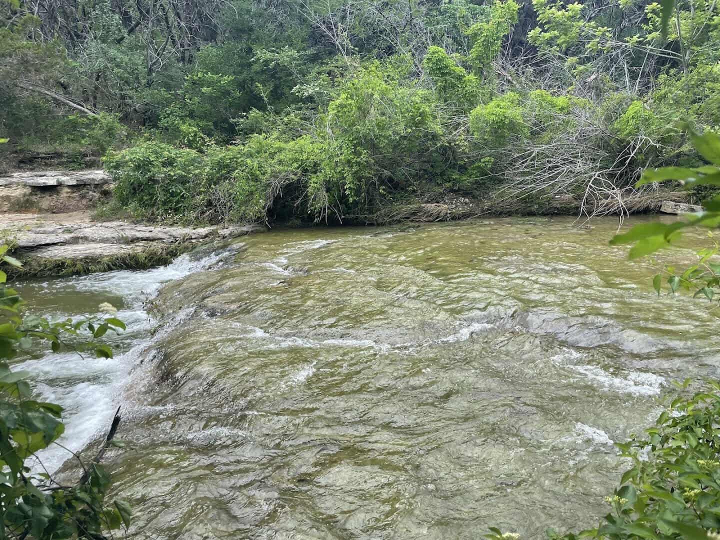 Water spilling over a limestone ledge on Bull Creek at St. Edward's Park in Austin
