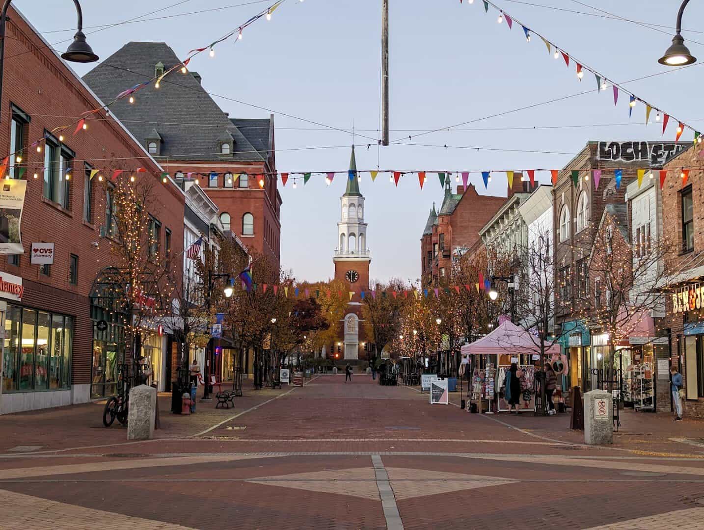 Church Street Marketplace with autumn foliage and a church steeple in Burlington, Vermont