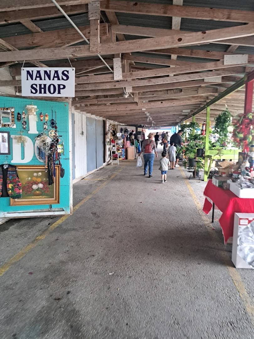 Long covered aisle of vendor stalls at Bussey's Flea Market in Schertz, Texas