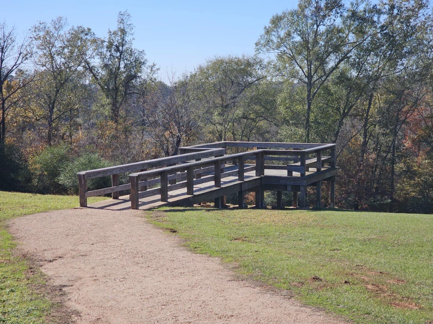 Walking trail and wooden bridge through the woods at Caddo Mounds State Historic Site