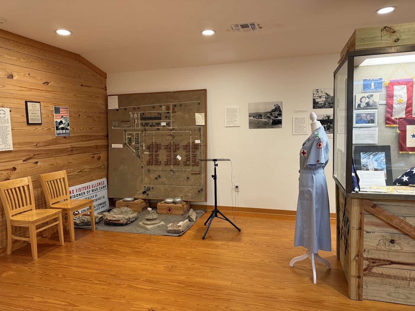 Exhibit room inside the replica barracks at Camp Hearne with camp model and displays