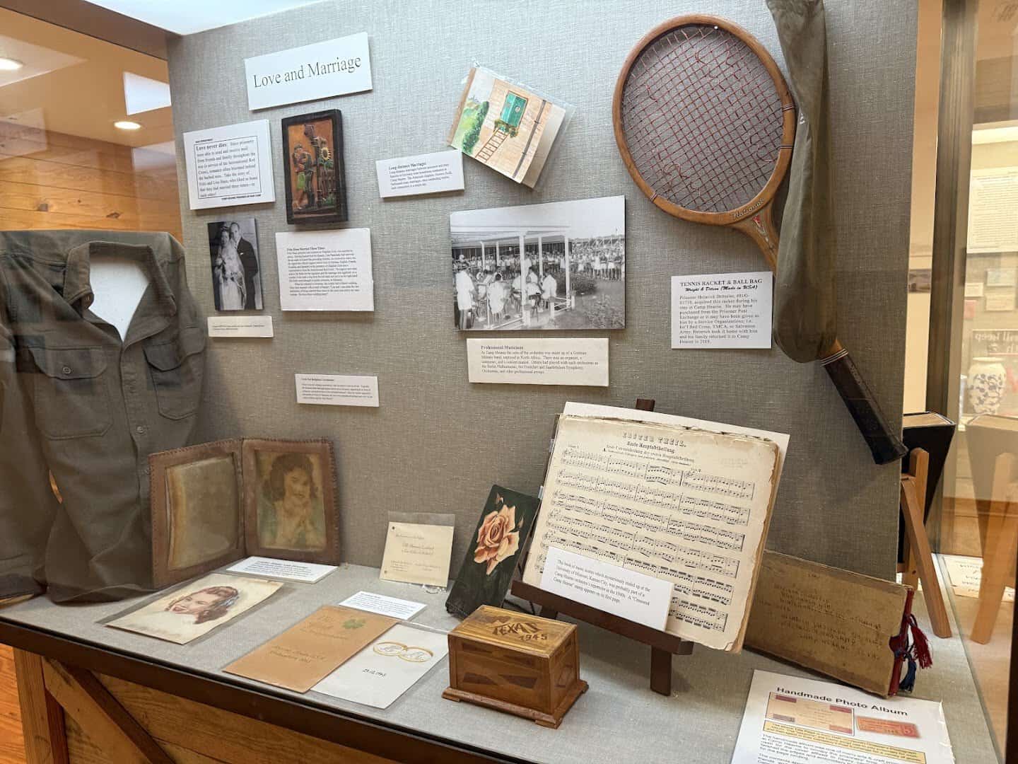 Exhibit case with wartime letters, a photo album and sheet music at Camp Hearne