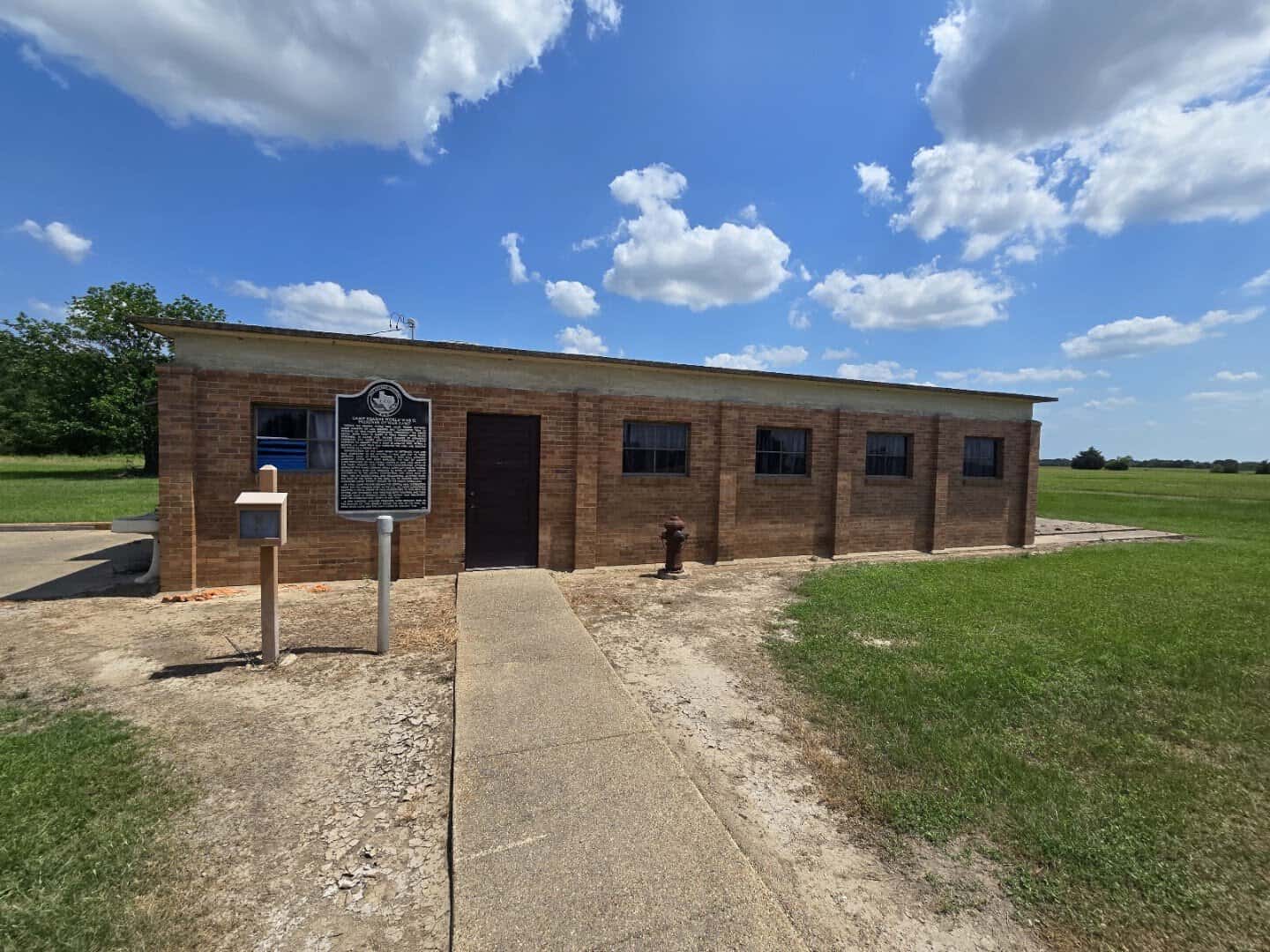Original brick building with Texas historical marker at Camp Hearne