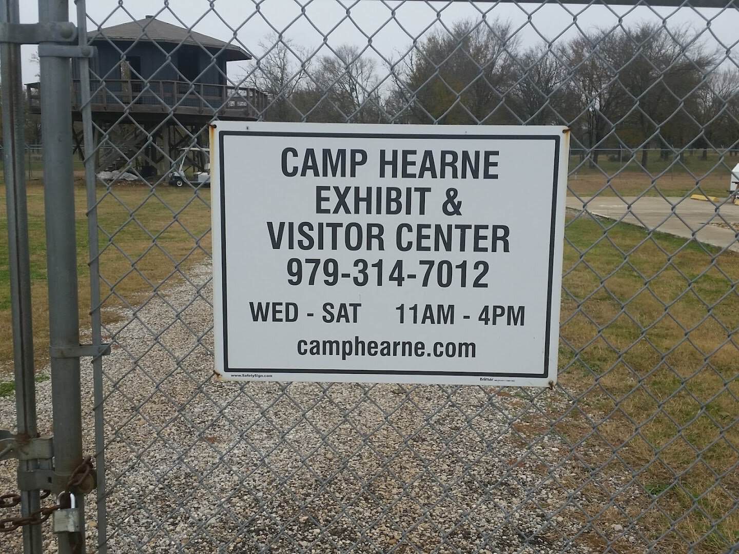 Camp Hearne Exhibit and Visitor Center sign with hours on the gate