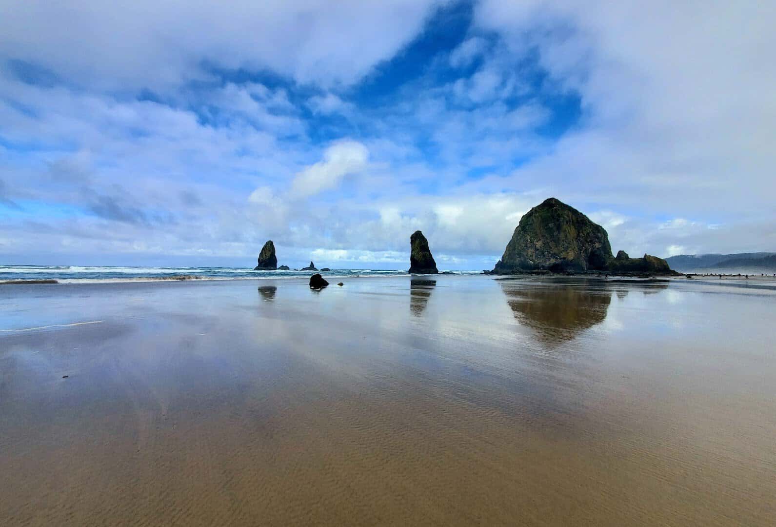 Haystack Rock rising over the wide sand at Cannon Beach, Oregon