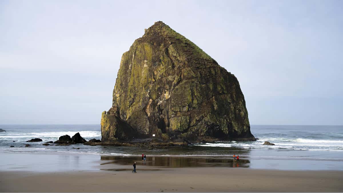 Haystack Rock rising from the beach, Cannon Beach, Oregon