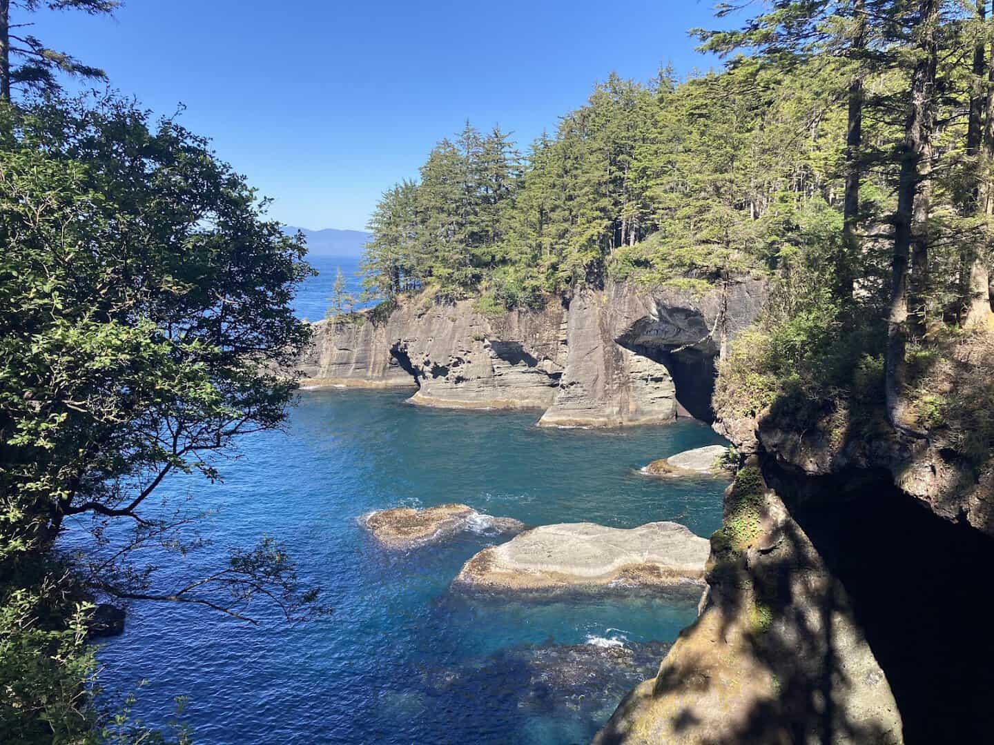 Sea caves and green water at the coves of Cape Flattery, the northwesternmost point of the Lower 48, Washington