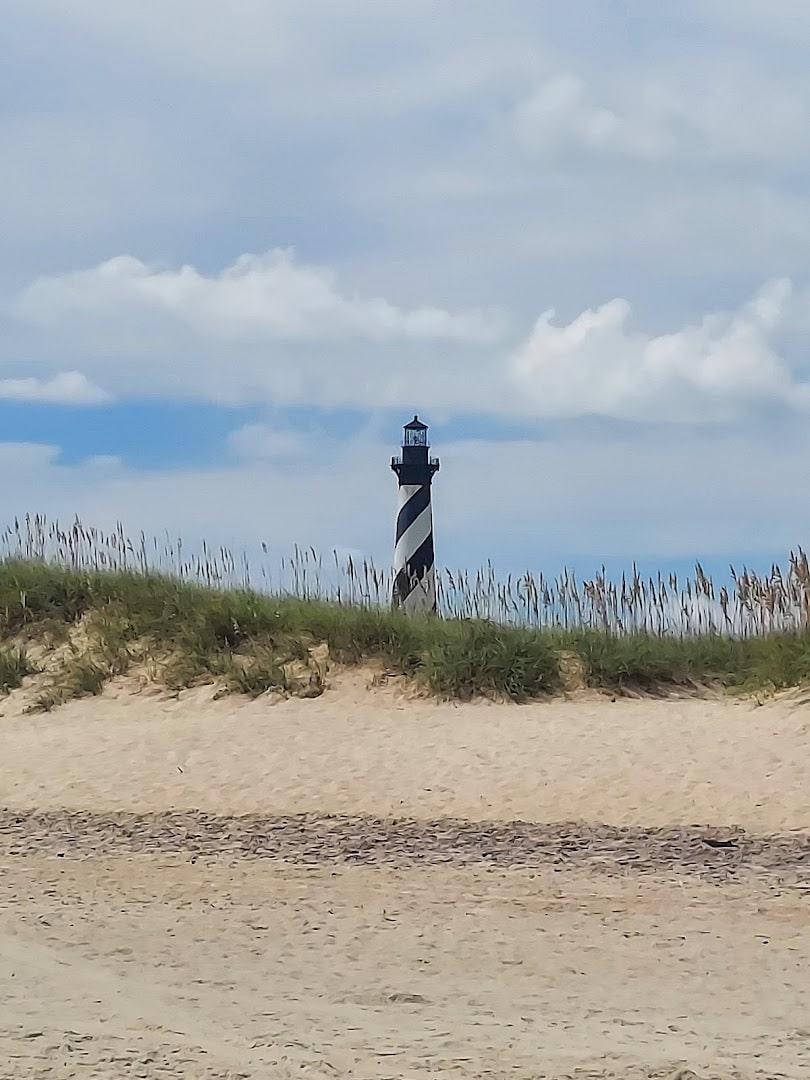 The striped Cape Hatteras Lighthouse over the dunes in Buxton, North Carolina