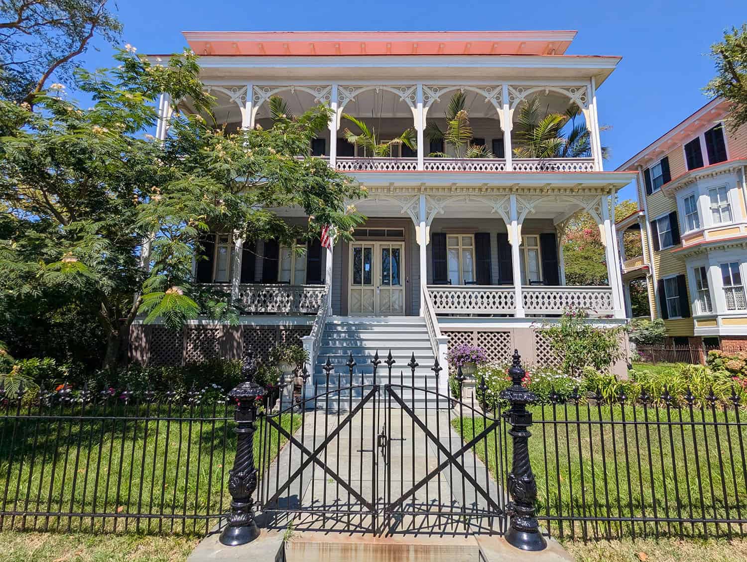 A pastel Victorian mansion with a wraparound porch in Cape May, New Jersey