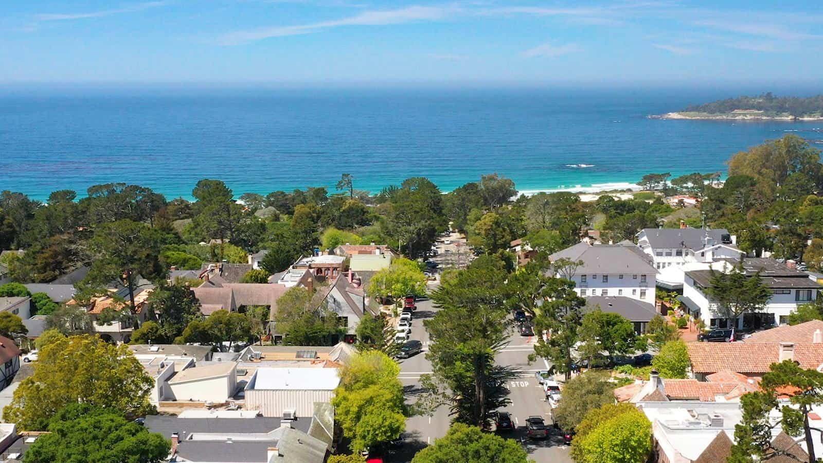Aerial view of Carmel-by-the-Sea village sloping to the beach, California
