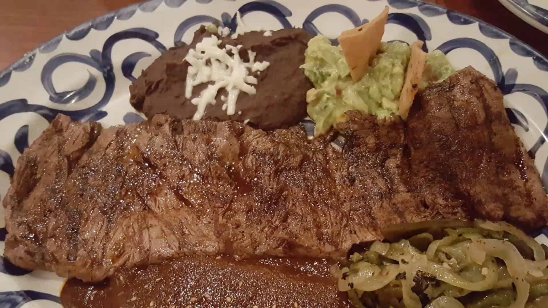 Carne asada with mole and guacamole at Fonda San Miguel in Austin