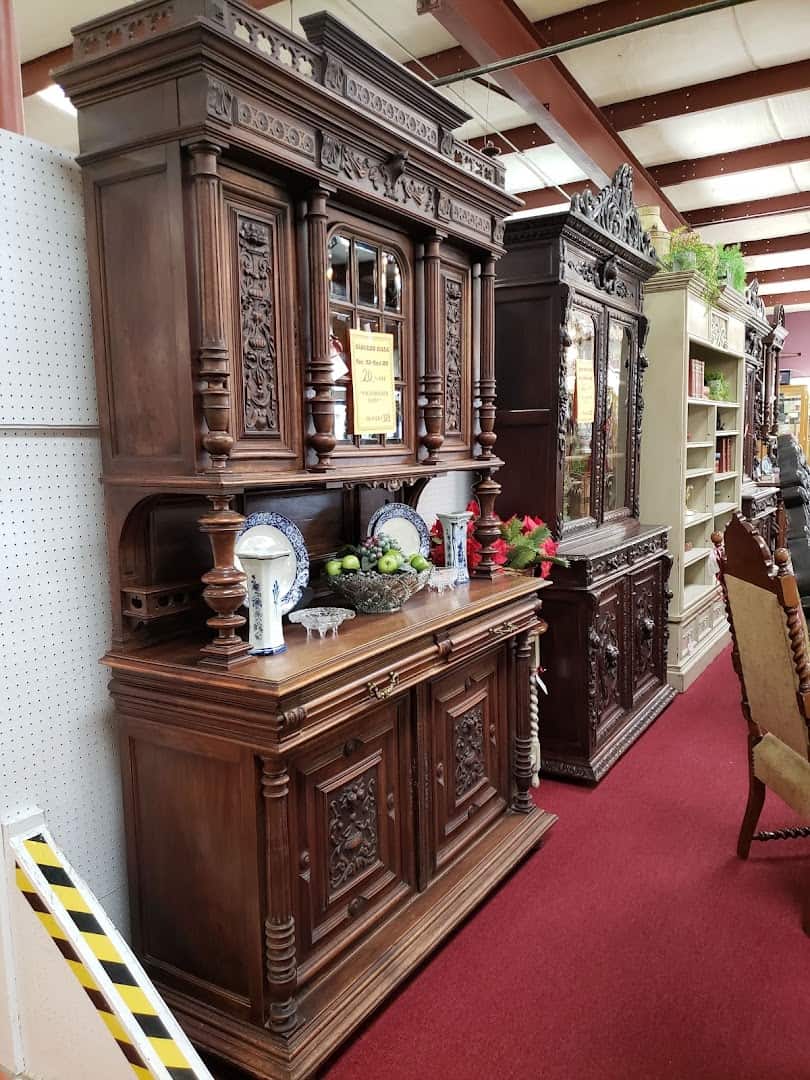 Tall carved wood antique hutch in a furniture booth at The Antique Gallery of Houston in Spring Texas