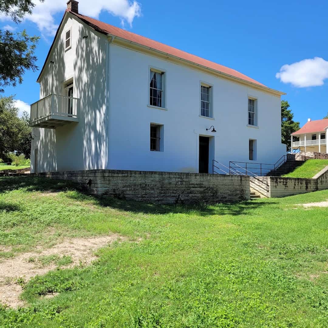 A historic white Alsatian-style building in Castroville, Texas