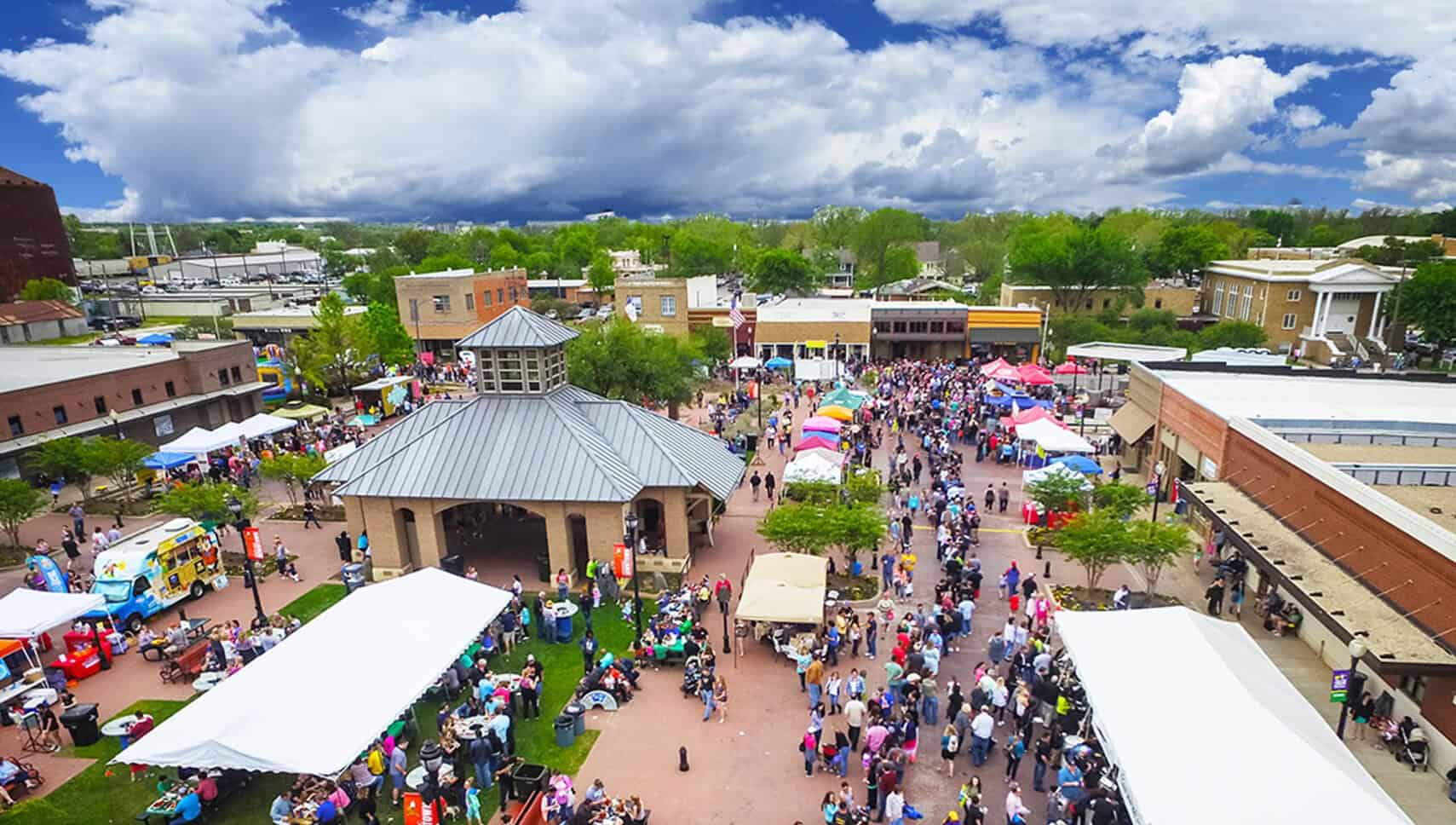 Aerial view of a Friday Night Market crowd and vendor tents on the Celina downtown square
