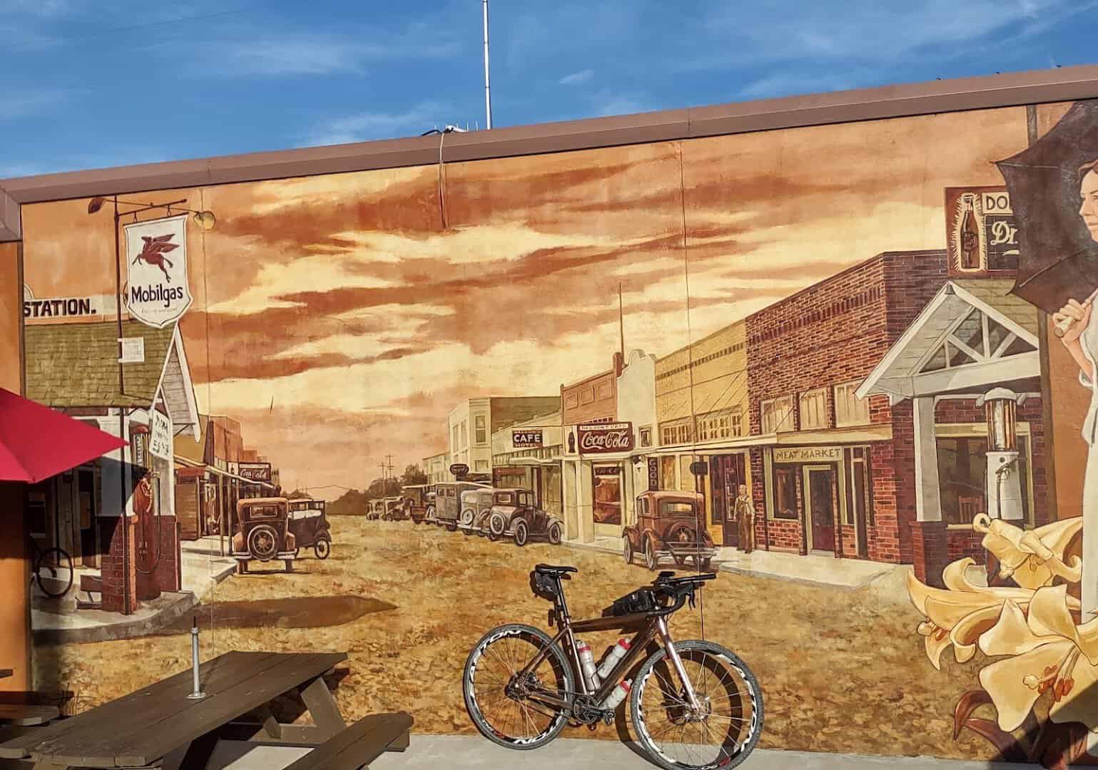 A mural of early Celina's main street with vintage cars painted on a downtown wall