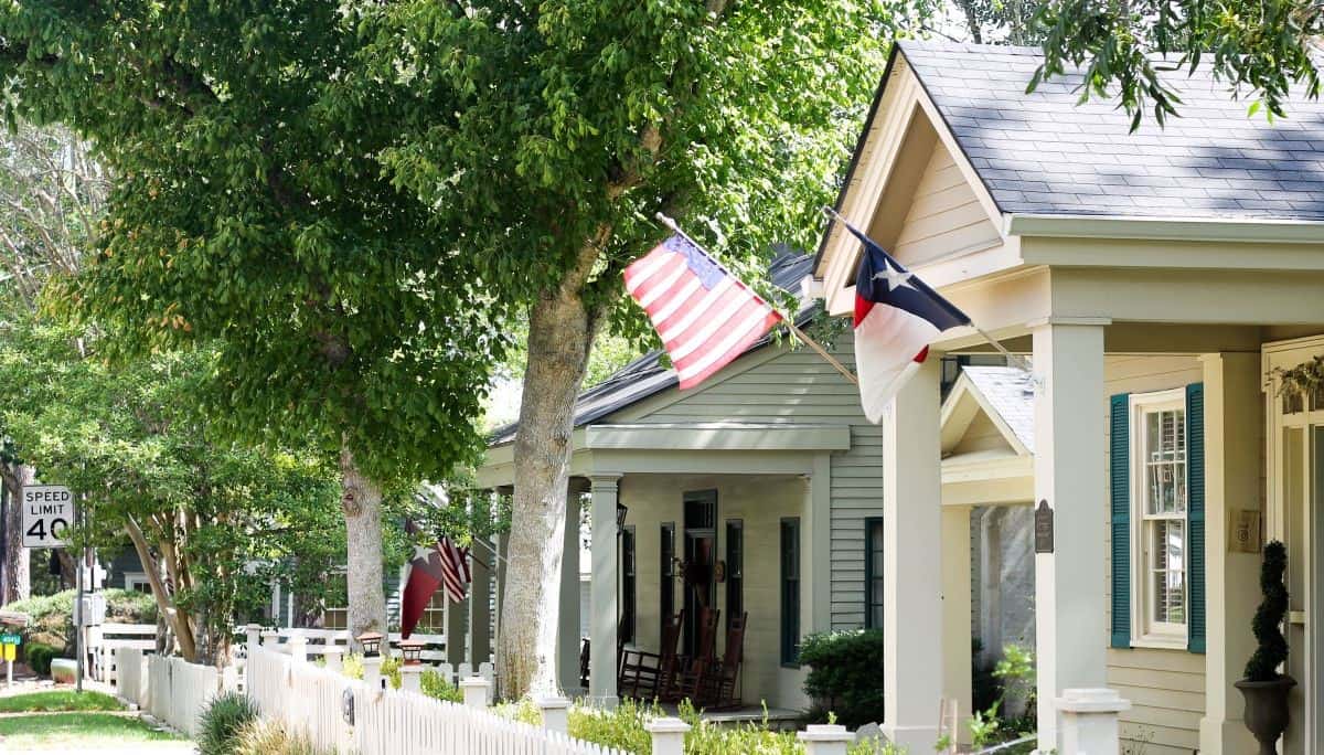 Restored historic home flying Texas and American flags in Chappell Hill