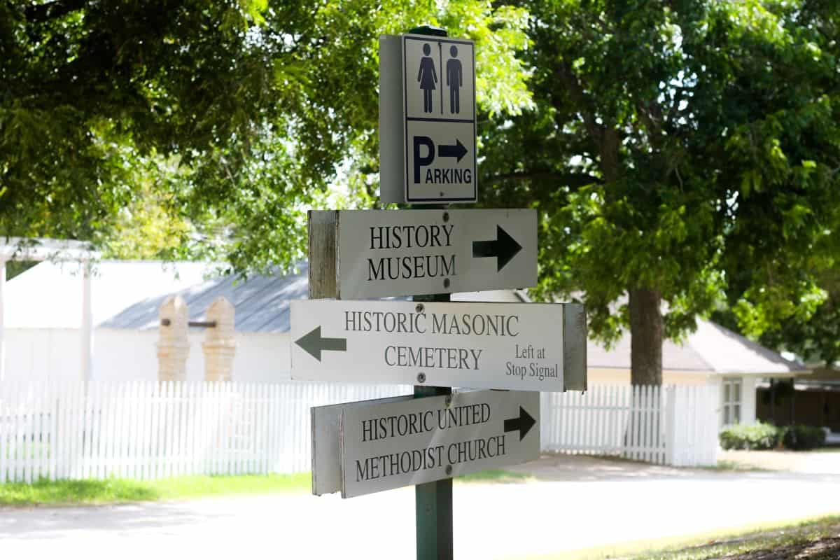 Signs pointing to the history museum, Masonic cemetery, and Methodist church in Chappell Hill
