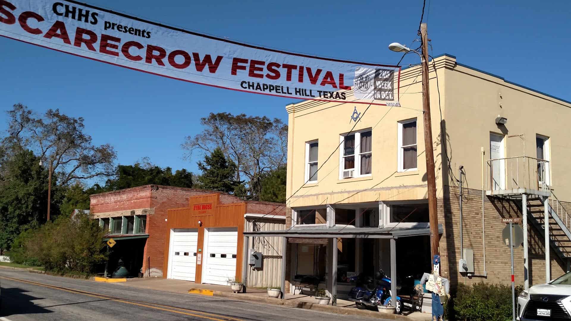 Scarecrow Festival banner over a downtown building in Chappell Hill, Texas