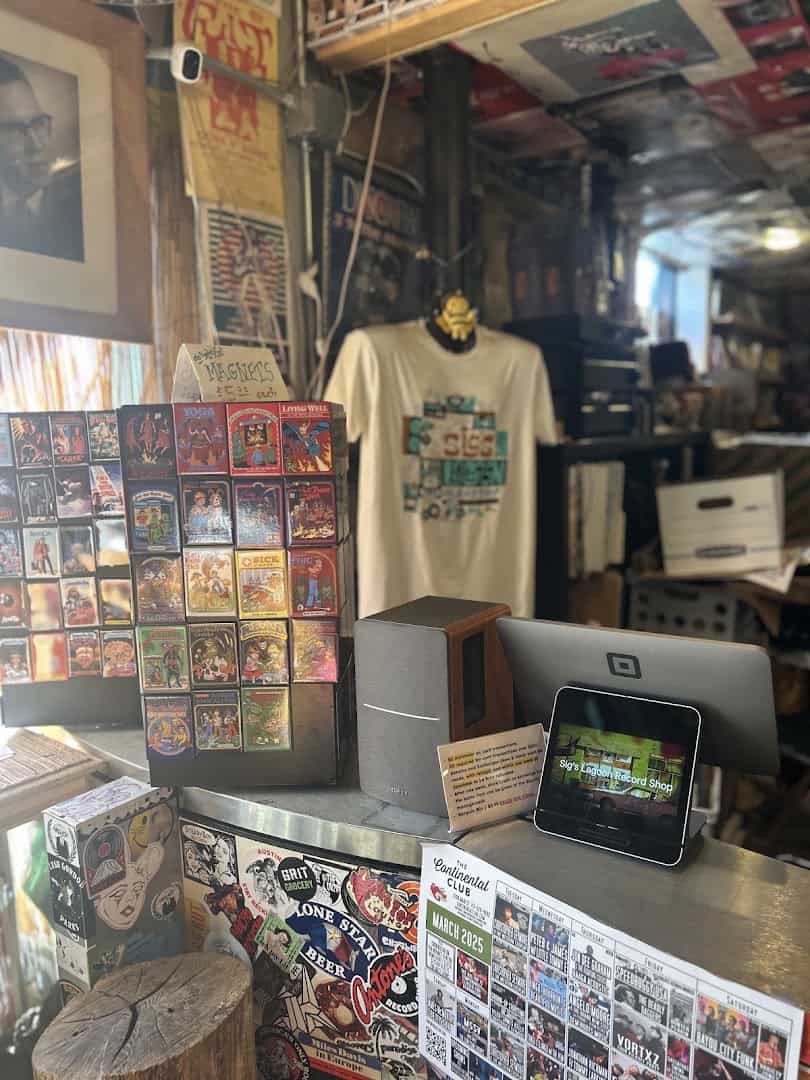 Checkout counter with magnets, a shop shirt and the Continental Club calendar at Sigs Lagoon