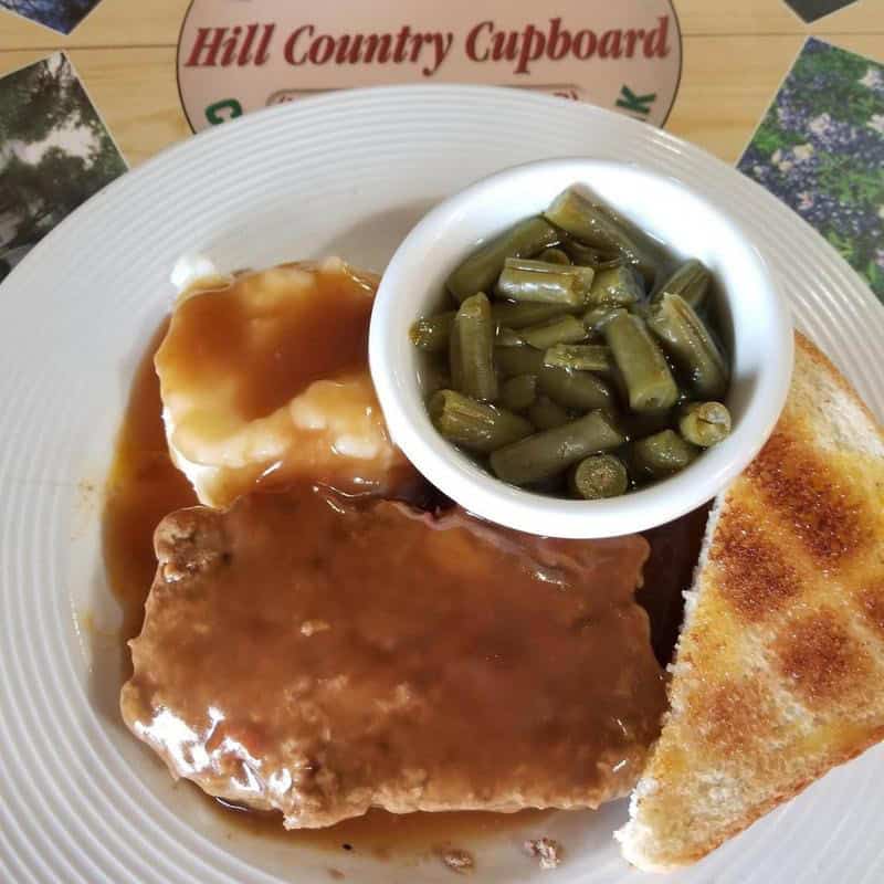 Chicken fried steak with gravy, green beans and Texas toast at Hill Country Cupboard