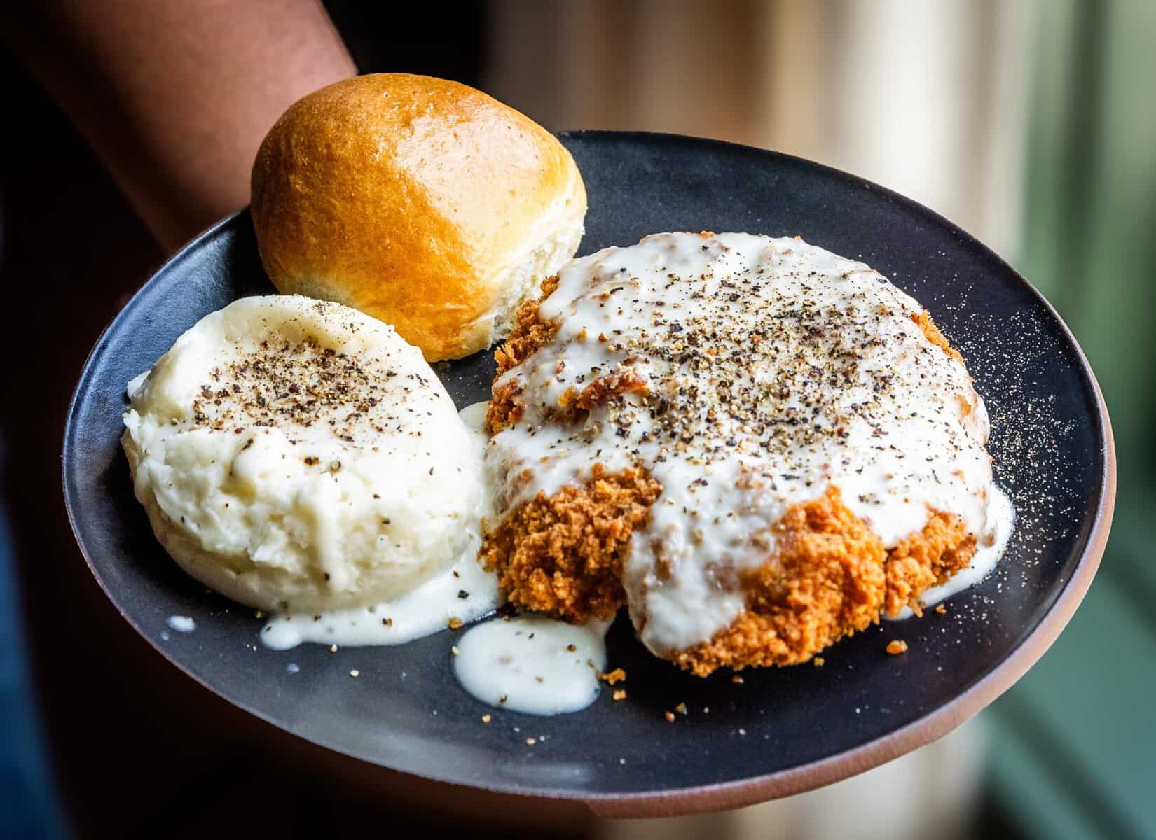 Chicken fried steak with mashed potatoes and a roll from Cafe Homestead at Homestead Heritage near Waco, Texas
