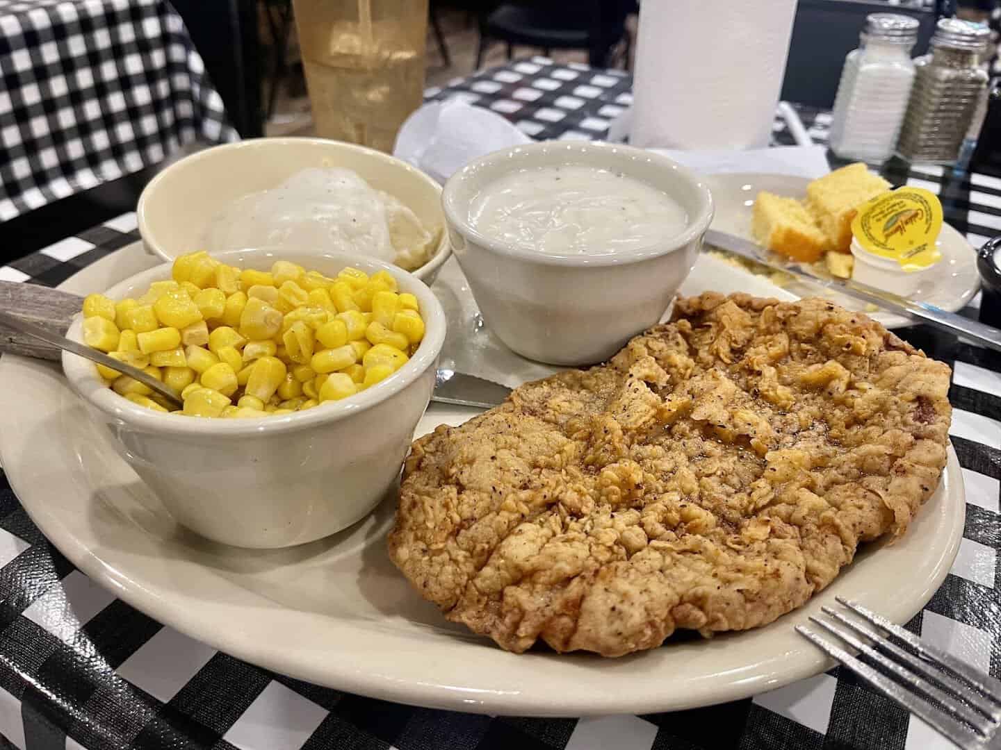Chicken fried steak with corn and cream gravy at Mels Country Cafe in Tomball, Texas