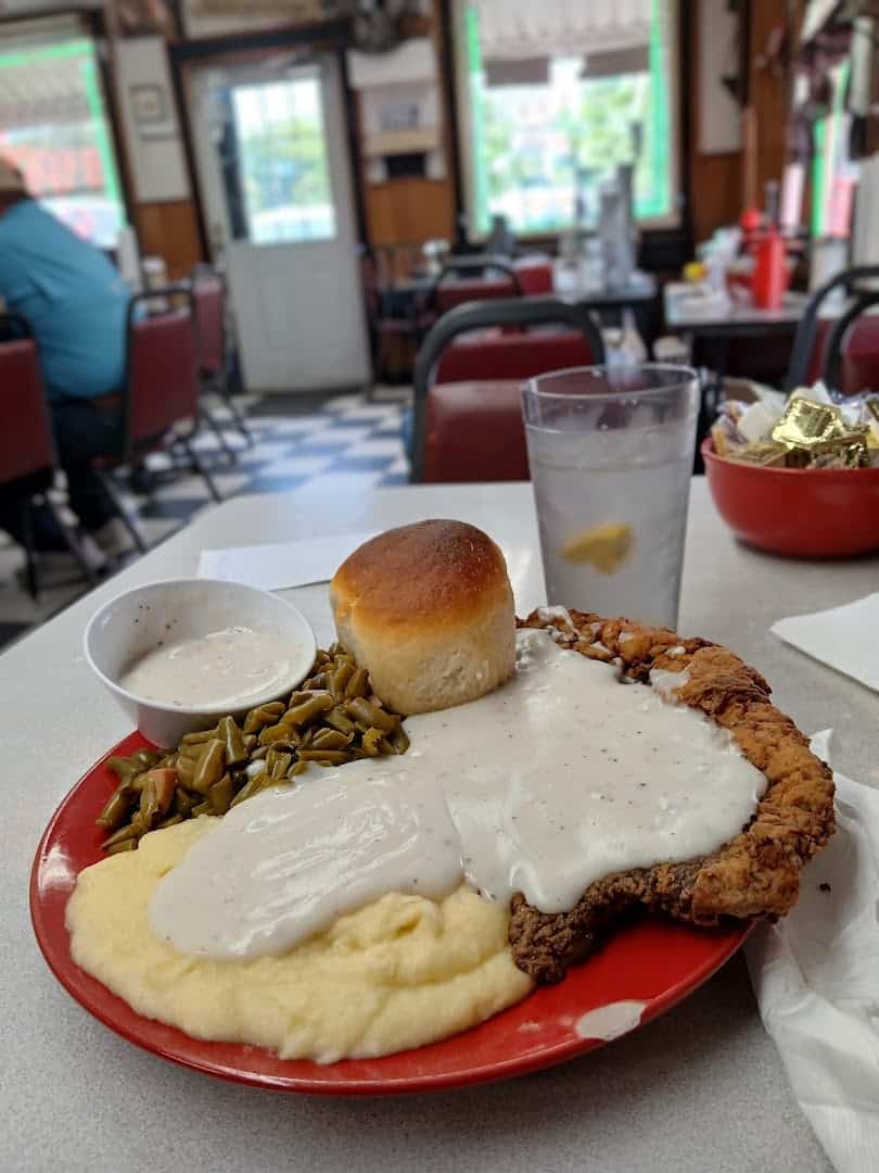Chicken fried steak under cream gravy with mashed potatoes and green beans at Whistle Stop Cafe in Decatur, Texas