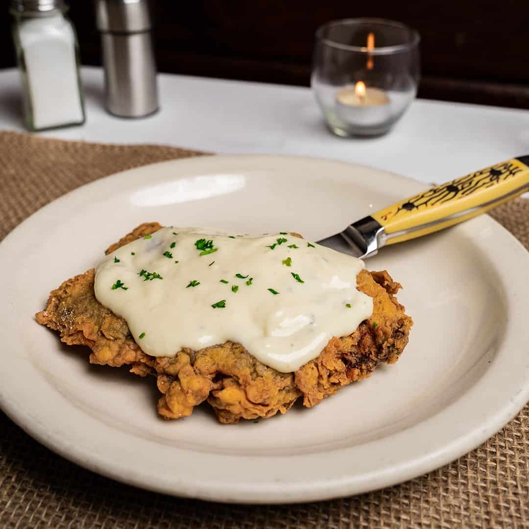 Chicken fried steak under thick cream gravy at Celebration Restaurant in Dallas