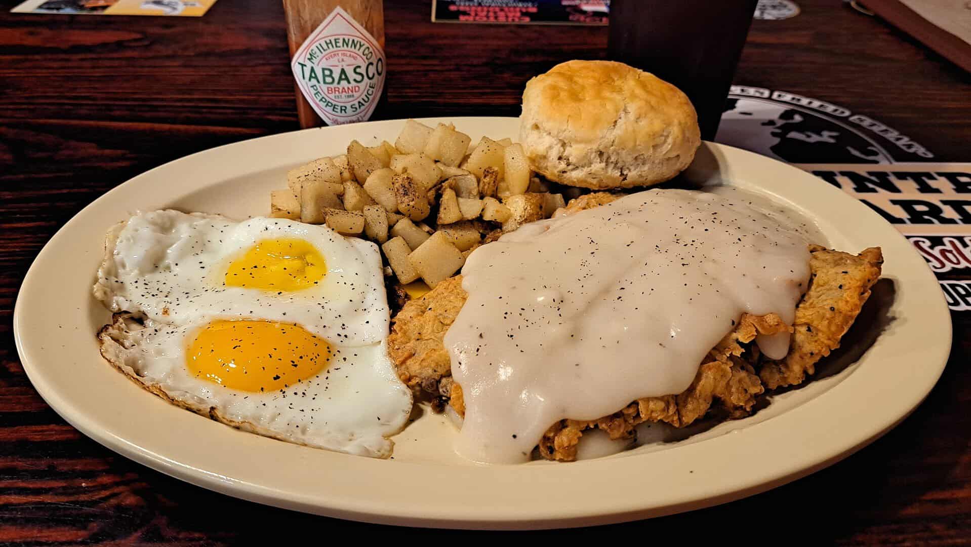 Hungry Man breakfast of chicken fried steak with eggs and a biscuit at Hill Country Cupboard