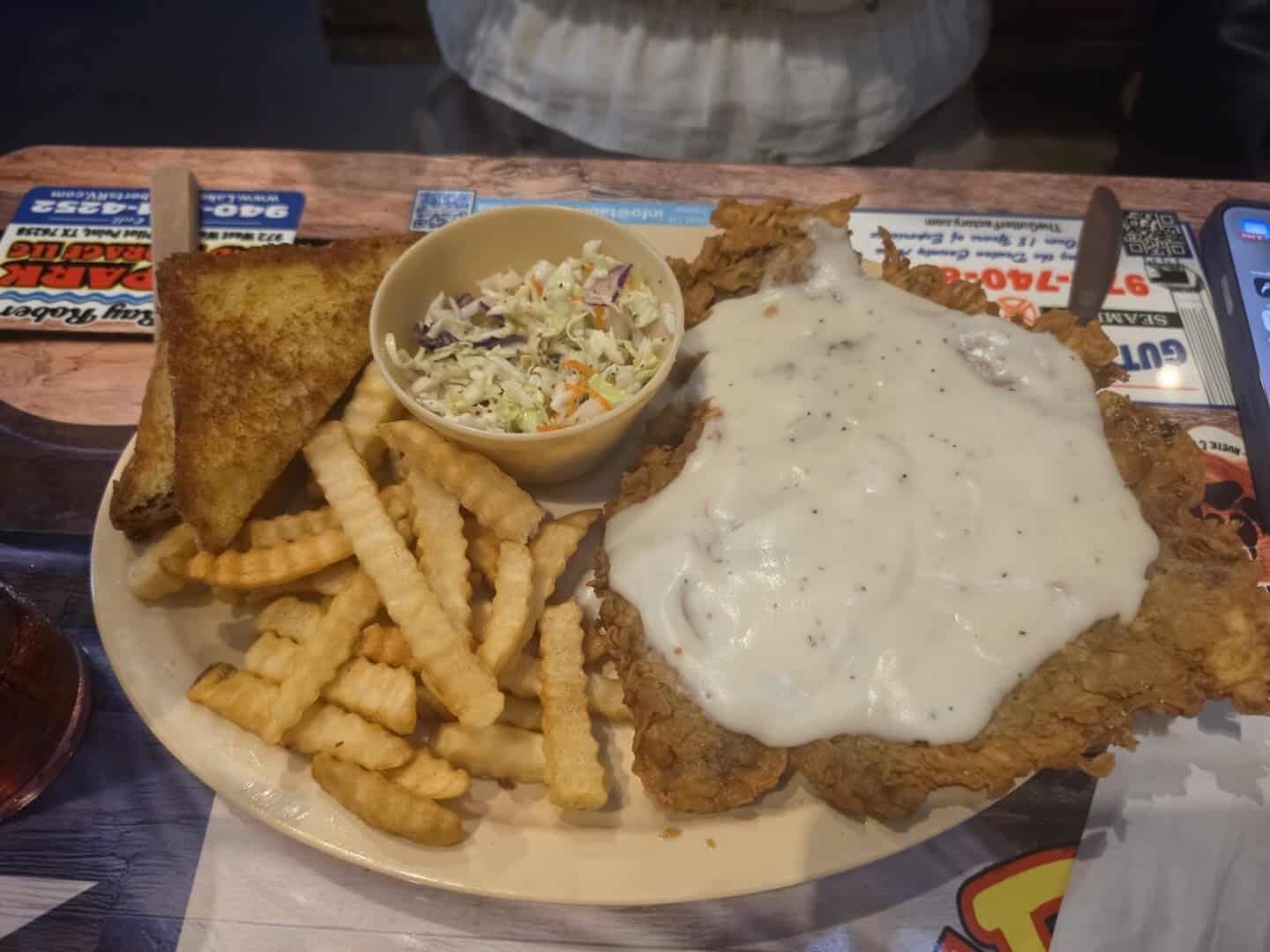 Chicken fried steak plate with crinkle fries and coleslaw at Bebo's and Kathy's Cafe in Pilot Point