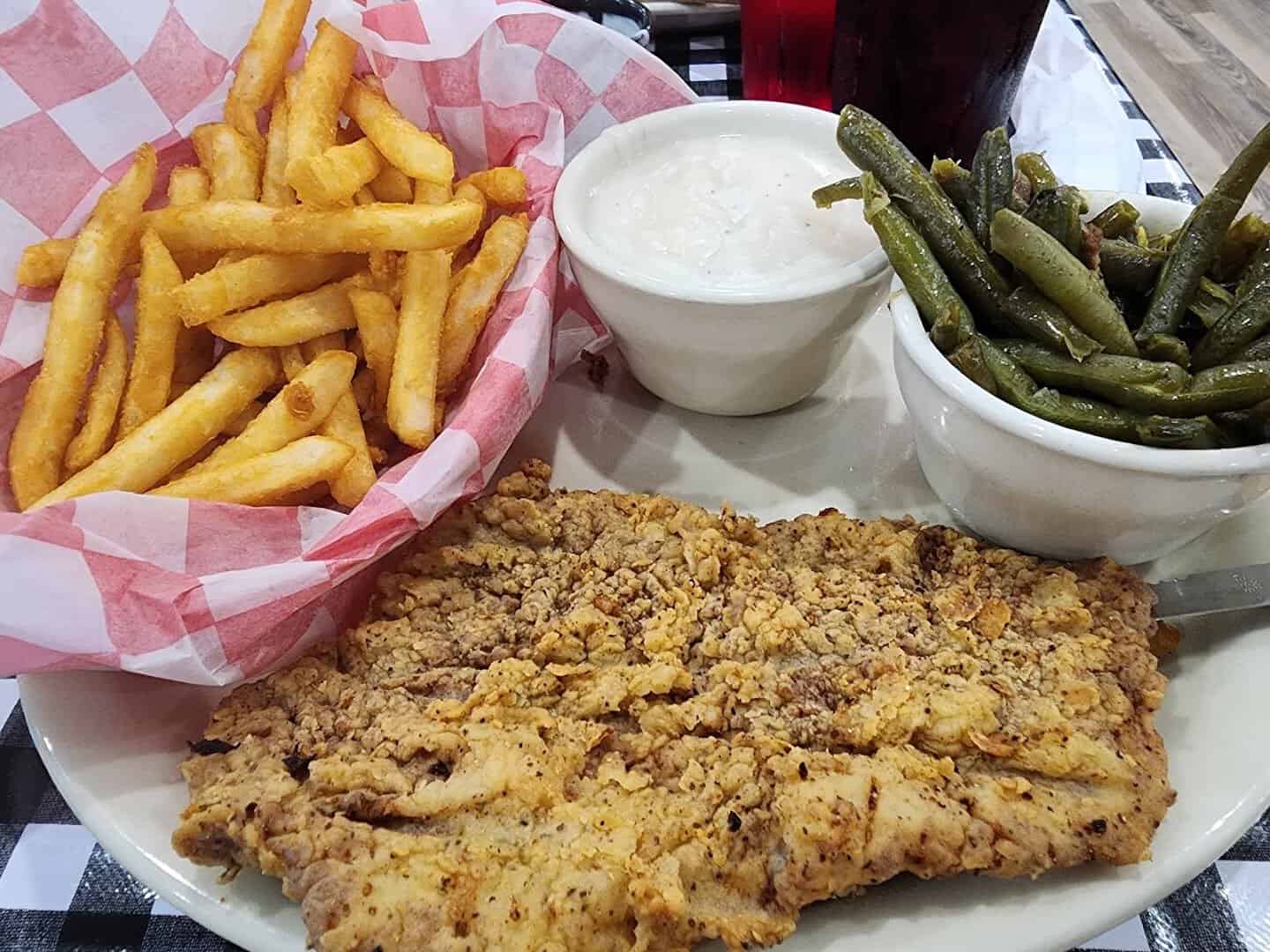 Chicken fried steak with fries and green beans at Mels Country Cafe in Tomball, Texas